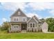 Charming two-story home featuring stone accents, a welcoming porch, and attached garage at 4225 Burlington Mills Rd, Wake Forest, NC 27587
