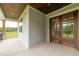 Inviting covered front porch featuring wood ceilings, gray siding, and elegant double front doors at 4225 Burlington Mills Rd, Wake Forest, NC 27587