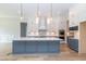 Spacious kitchen with white and gray cabinets, a marble island, and stainless steel appliances at 4225 Burlington Mills Rd, Wake Forest, NC 27587