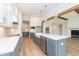 Open-concept kitchen featuring a large island, stainless steel appliances, and custom cabinets at 4225 Burlington Mills Rd, Wake Forest, NC 27587