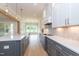 Modern kitchen with stainless steel appliances, white cabinets, and an elegant island at 4225 Burlington Mills Rd, Wake Forest, NC 27587