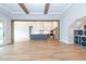 Open-concept living area with hardwood floors and a view into the modern kitchen at 4225 Burlington Mills Rd, Wake Forest, NC 27587