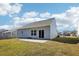 A home's backyard features a sliding glass door and a small concrete patio at 425 Legacy Dr, Youngsville, NC 27596