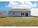 Rear view of a home showing a patio and sliding glass doors to the grassy backyard at 425 Legacy Dr, Youngsville, NC 27596