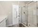 Bathroom featuring a glass shower and open door to the Primary bedroom at 425 Legacy Dr, Youngsville, NC 27596