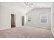 Bright, spacious bedroom with ceiling fan, carpet, and natural light at 425 Legacy Dr, Youngsville, NC 27596