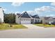 Well-maintained home featuring a two-car garage, neat lawn, and solar panels on the roof at 425 Legacy Dr, Youngsville, NC 27596