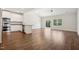 Bright living room with wood floors, white cabinets, and sliding glass doors to bring in natural light at 425 Legacy Dr, Youngsville, NC 27596