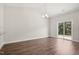 Light-filled living area with laminate wood flooring and sliding glass door access at 425 Legacy Dr, Youngsville, NC 27596