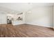 Sunlit living room with laminate wood flooring and an easy flow to kitchen at 425 Legacy Dr, Youngsville, NC 27596