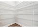 Spacious walk-in pantry with white shelving and hardwood floor at 425 Legacy Dr, Youngsville, NC 27596