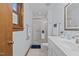 Bright bathroom with a glass-enclosed shower, white vanity, and wooden window trim at 428 Seasons Dr, Raleigh, NC 27614