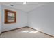 A bedroom with neutral carpet and wood trim around the window and baseboard at 428 Seasons Dr, Raleigh, NC 27614