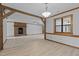 Open concept living room area featuring wood beam and brick fireplace at 428 Seasons Dr, Raleigh, NC 27614