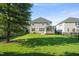 Large, fenced backyard with lush green grass, mature trees, and screened porch—perfect for outdoor entertaining at 4508 Brintons Cottage St, Raleigh, NC 27616