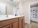 This bathroom features a double sink vanity with wooden cabinets and a toilet/shower room at 4508 Brintons Cottage St, Raleigh, NC 27616