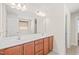 Bathroom vanity with double sinks, a large mirror, and ample storage space at 4508 Brintons Cottage St, Raleigh, NC 27616