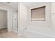 Bright bathroom featuring a soaking tub, a glass-enclosed shower, and neutral tiling at 4508 Brintons Cottage St, Raleigh, NC 27616