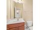 Bathroom vanity with white countertop, wood cabinets, toilet, and mirror at 4508 Brintons Cottage St, Raleigh, NC 27616