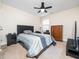 This bedroom features a ceiling fan, a large bed, a dresser, and a mounted television at 4508 Brintons Cottage St, Raleigh, NC 27616