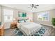 Inviting main bedroom featuring a tray ceiling, a ceiling fan, and two bright windows at 4508 Brintons Cottage St, Raleigh, NC 27616