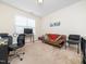 Bright bedroom featuring neutral walls, a comfortable sofa bed, and a large window at 4508 Brintons Cottage St, Raleigh, NC 27616