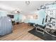 Spacious bonus room area with exercise equipment, fan, and wood flooring at 4508 Brintons Cottage St, Raleigh, NC 27616