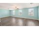 Bright bonus room featuring hardwood floors, a ceiling fan, and three large windows at 4508 Brintons Cottage St, Raleigh, NC 27616