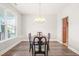 Formal dining room featuring modern chandelier, chair rail, and large window at 4508 Brintons Cottage St, Raleigh, NC 27616