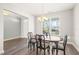 Formal dining room with modern chandelier, hardwood floors, and large window at 4508 Brintons Cottage St, Raleigh, NC 27616