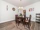 Dining area with dark wood furniture, chandelier and hardwood style floors at 4508 Brintons Cottage St, Raleigh, NC 27616