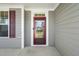 Charming front door with a red frame and glass panel, allowing natural light into the entryway at 4508 Brintons Cottage St, Raleigh, NC 27616