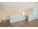 Hallway featuring hardwood floors, neutral walls, and natural light from multiple windows at 4508 Brintons Cottage St, Raleigh, NC 27616