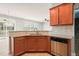 Cozy kitchen featuring granite countertops, a stainless steel dishwasher, and seamless access to living spaces at 4508 Brintons Cottage St, Raleigh, NC 27616