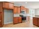 Charming kitchen featuring wood cabinets, granite countertops, stainless steel appliances, and tiled backsplash at 4508 Brintons Cottage St, Raleigh, NC 27616