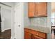 Kitchen nook featuring wood cabinets, granite countertops, tiled backsplash, and tile flooring at 4508 Brintons Cottage St, Raleigh, NC 27616
