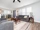 Open-concept living room with ceiling fan, wood floors and large windows at 4508 Brintons Cottage St, Raleigh, NC 27616
