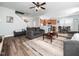Open-concept living room with wood floors, ceiling fan, and neutral color palette at 4508 Brintons Cottage St, Raleigh, NC 27616