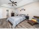 Spacious bedroom featuring a tray ceiling, windows, and hardwood floors at 4508 Brintons Cottage St, Raleigh, NC 27616