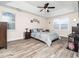 Bedroom featuring a ceiling fan, windows, a tray ceiling, and ample natural light at 4508 Brintons Cottage St, Raleigh, NC 27616