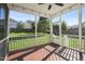 View of screened in porch with wood deck and string lights overlooking backyard at 4508 Brintons Cottage St, Raleigh, NC 27616