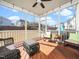 Screened-in porch with wooden floor, wicker furniture, and neighborhood views at 4508 Brintons Cottage St, Raleigh, NC 27616