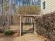 Backyard gate with stone steps entering an area surrounded by mature landscaping and trees at 47 Dover Grant Ct, Chapel Hill, NC 27517