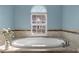 Close-up of an oval bathtub with a view out the window at 47 Dover Grant Ct, Chapel Hill, NC 27517