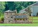 Stone entrance sign for Birchwood Grove, set against a lush green backdrop with flowering plants at 51 Robert Howe Dr, Fuquay Varina, NC 27526