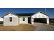 Exterior view of a new home under construction, featuring Tyvek home wrap and a two-car garage at 51 Robert Howe Dr, Fuquay Varina, NC 27526