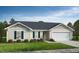 Charming single-story home with neutral siding, a two-car garage, and well-maintained landscaping at 51 Robert Howe Dr, Fuquay Varina, NC 27526