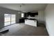 Spacious kitchen featuring sleek black cabinetry, a peninsula with breakfast bar, and sliding glass doors at 51 Robert Howe Dr, Fuquay Varina, NC 27526