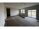 Bright living room with recessed lighting, large windows, and sliding door, offering ample natural light at 51 Robert Howe Dr, Fuquay Varina, NC 27526