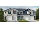 Charming townhomes feature varied siding colors, covered front entryways, and attached one car garages at 521 Eastwood St, Durham, NC 27703